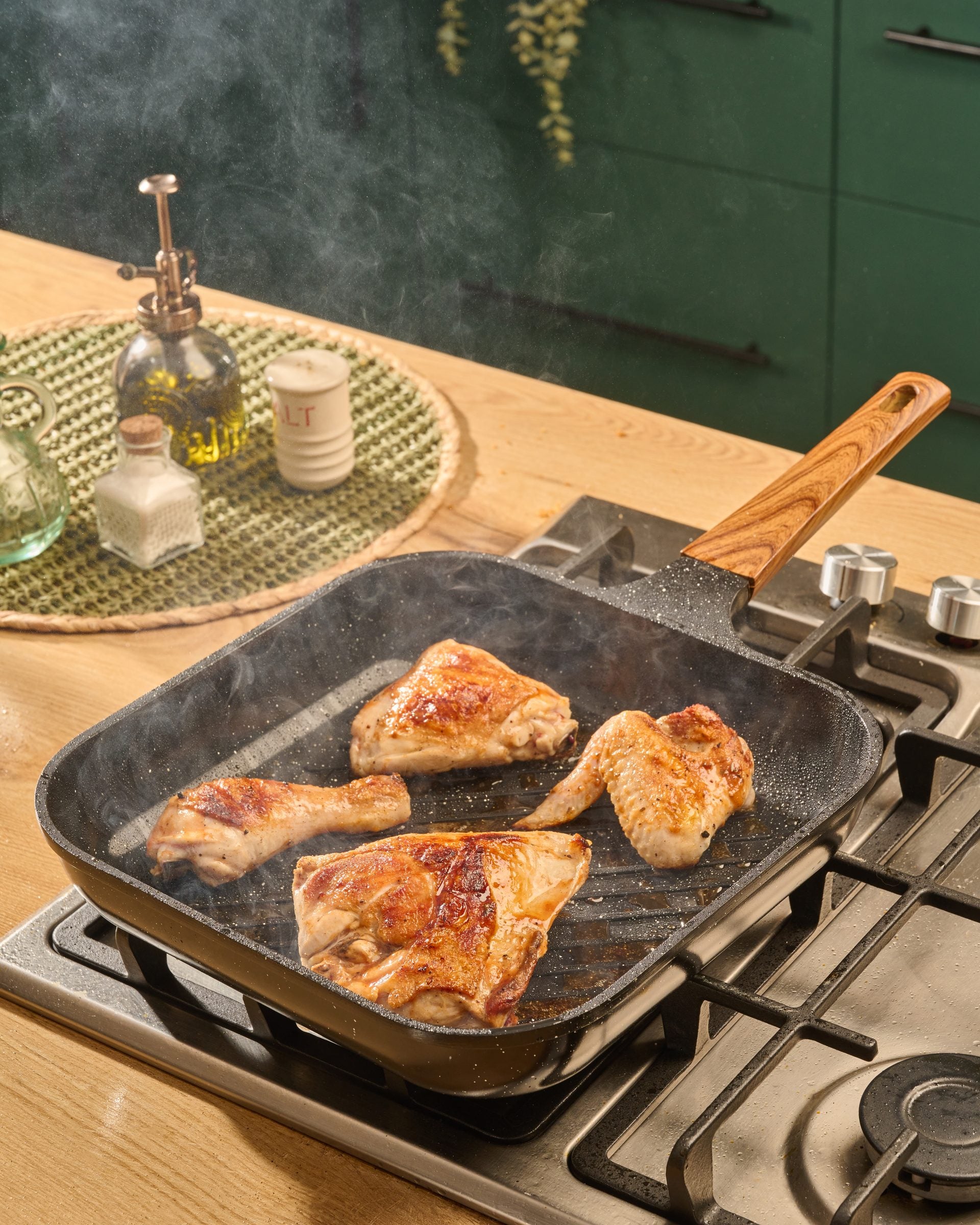 Granova black Grill Pan 28 cm cooking chicken on a stovetop