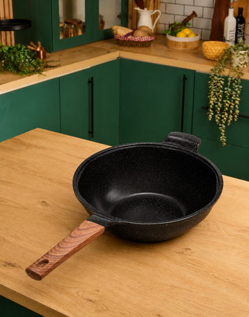 Granova black Wok Pan 28 cm displayed empty in a modern kitchen